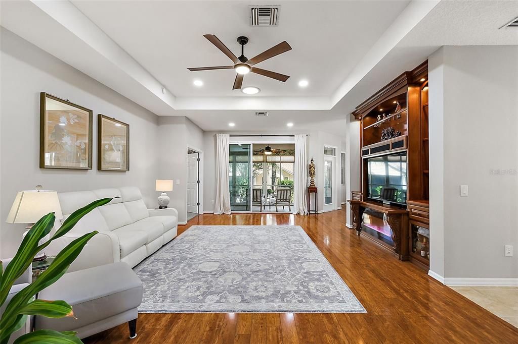 Living room with built-in.  Sliding doors go out to the heated/cooled lanai.