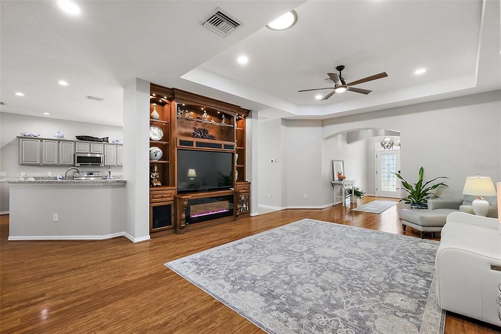 Living room with views to the kitchen and front foyer.