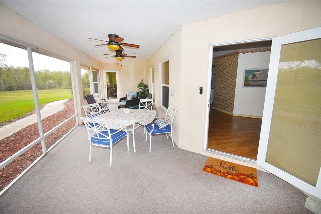 Front door access to home off east screened patio