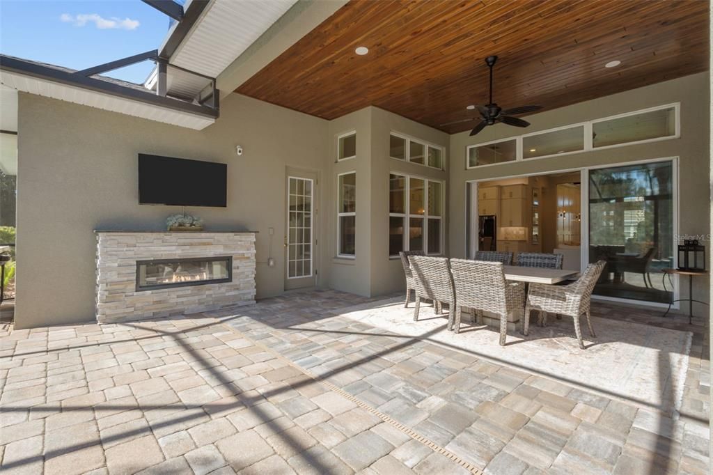 Back Patio with pavers, wood plank ceilings, full wall of sliders, fireplace