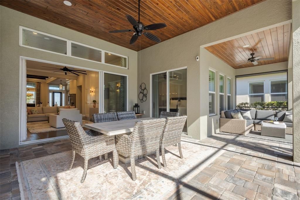 Back Patio with pavers, wood plank ceilings, full wall of sliders