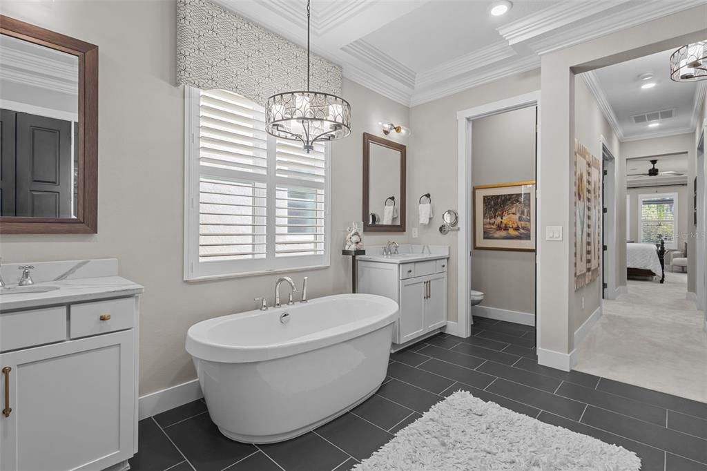 Primary Bathroom - quart counters, freestanding tub, walk in frameless shower