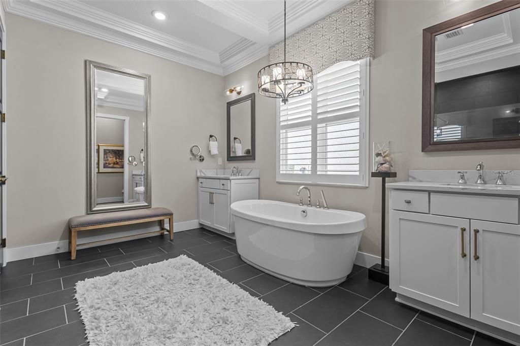 Primary Bathroom - quart counters, freestanding tub, walk in frameless shower