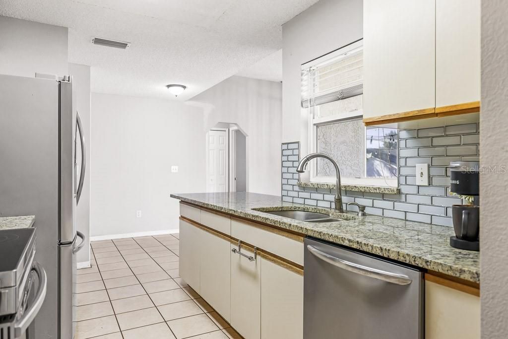 Kitchen with granite and stainless appliances