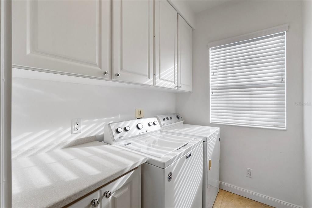 laundry room with upper cabinets