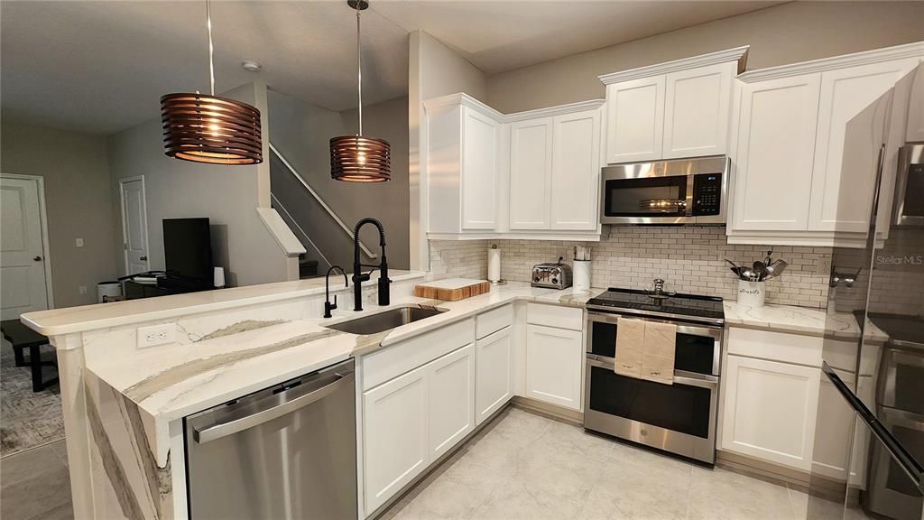 Kitchen with upgraded appliances and Quartz Countertops