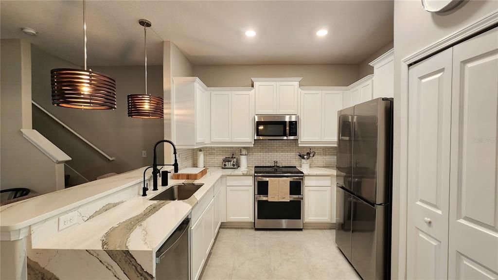 Kitchen with upgraded appliances and Quartz Countertops