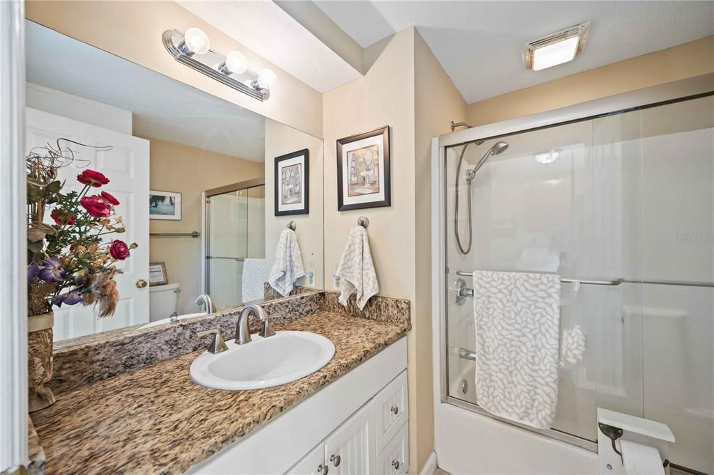 Guest bathroom with tab and granite counter top