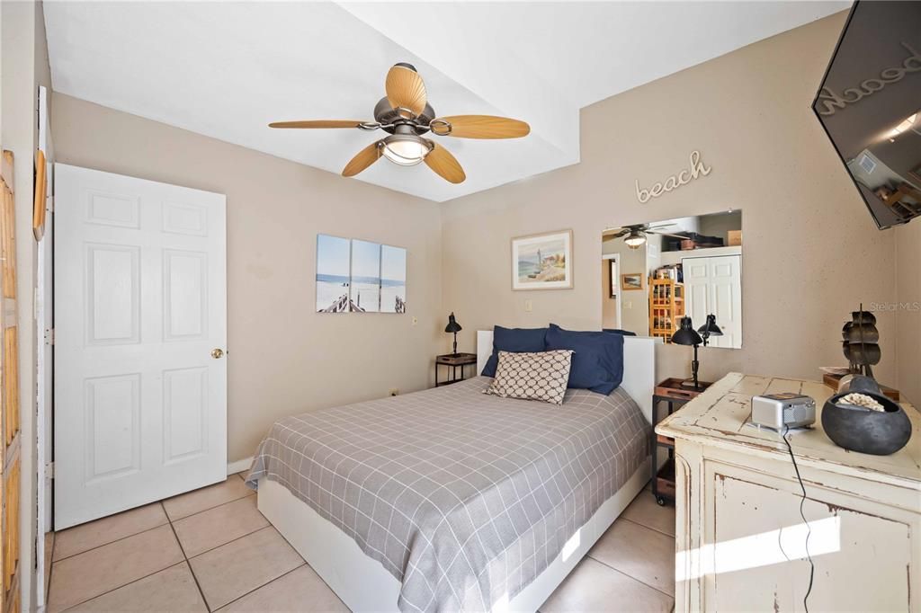 Guest bedroom with tile flooring