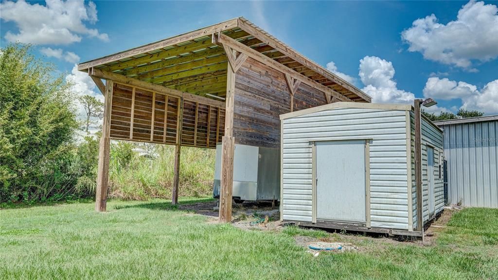 RV Carport Behind Barn