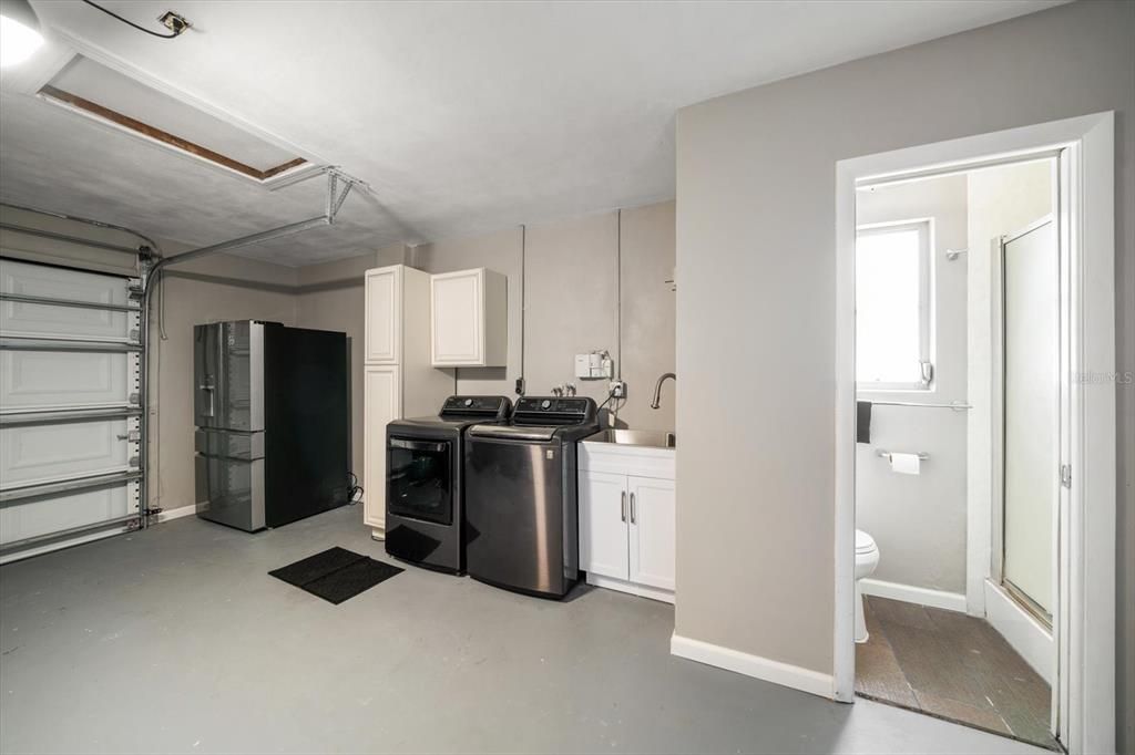 Garage with laundry and additional bath