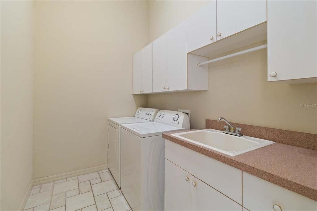 Laundry room with utility sink and extra cabinets