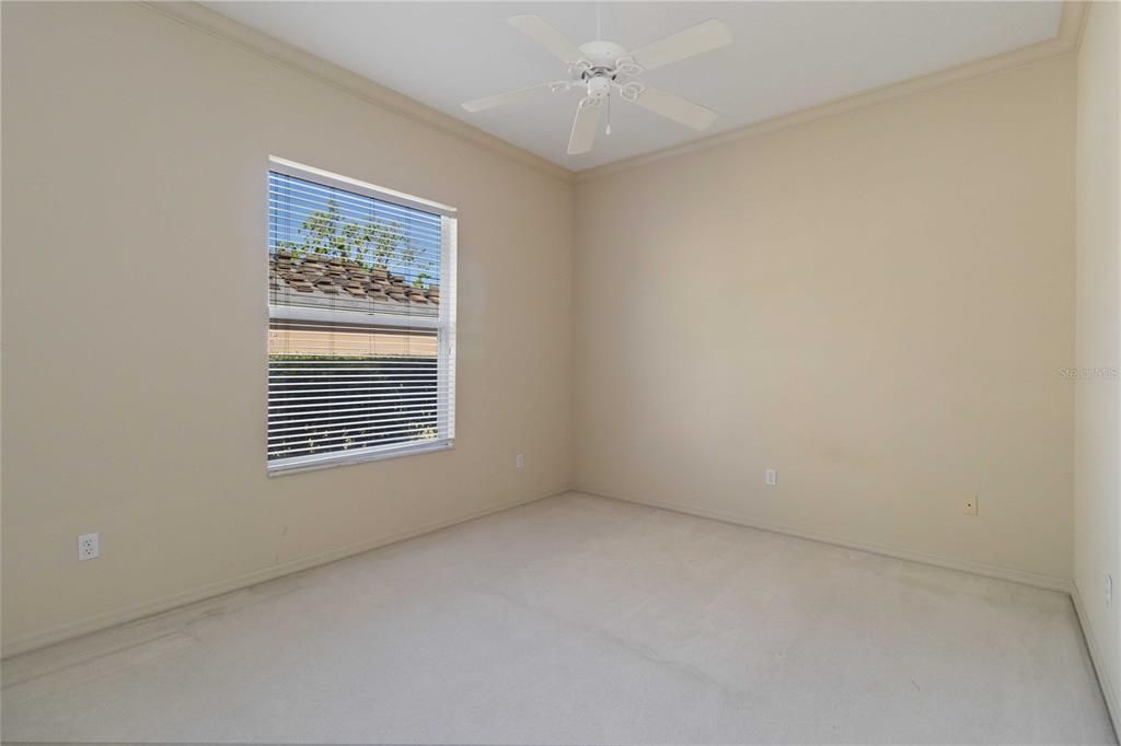 Guest bedroom with carpet flooring and ceiling fan