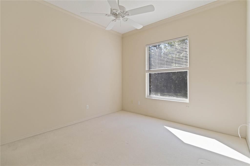 guest bedroom with crown molding