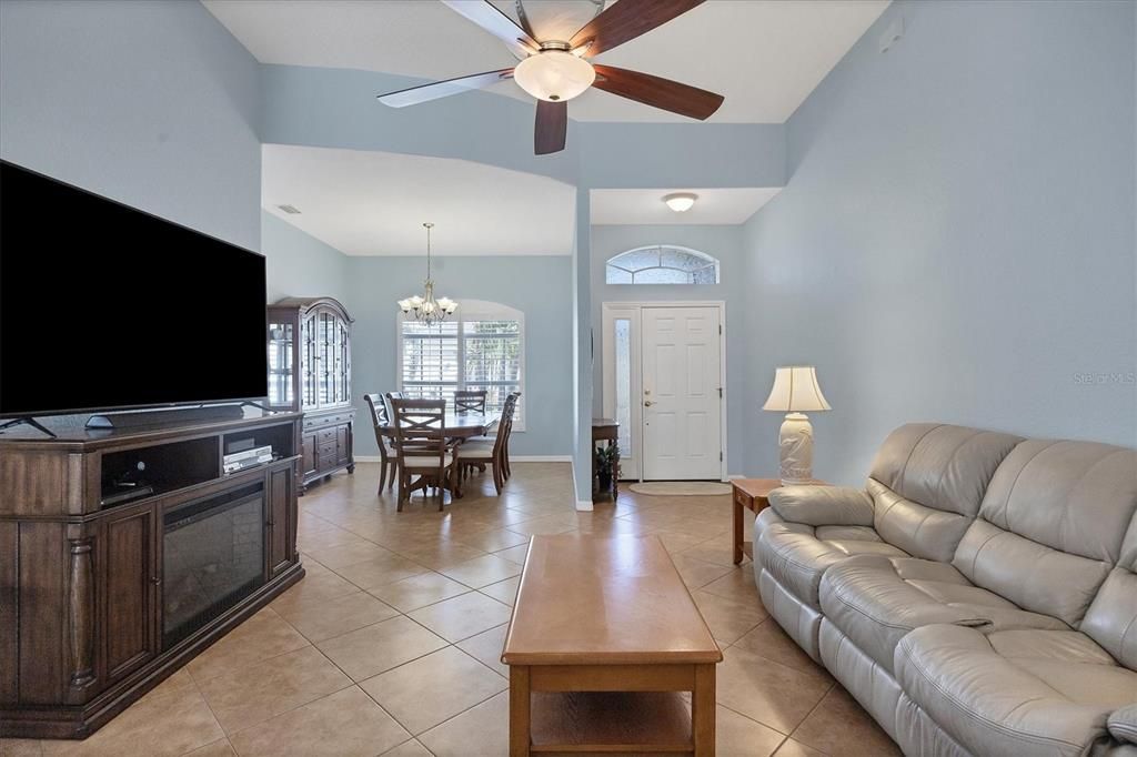 VIEW FROM FRENCH DOORS TO FLORIDA ROOM SHOWING GREAT ROOM, DINING AND ENTRY