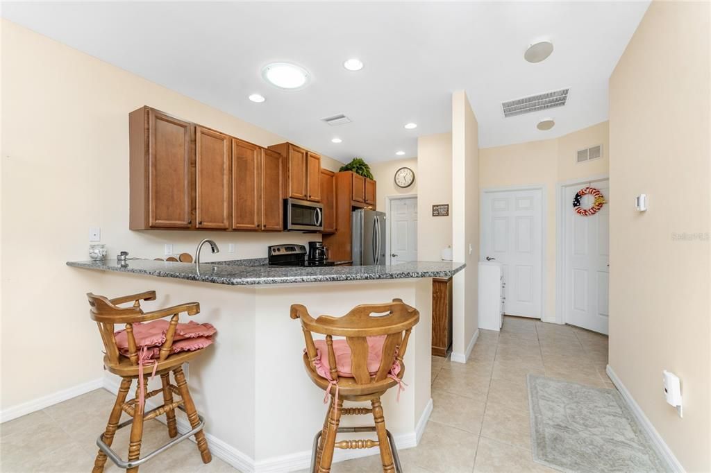 The kitchen features a breakfast bar and tubular skylight for extra light.