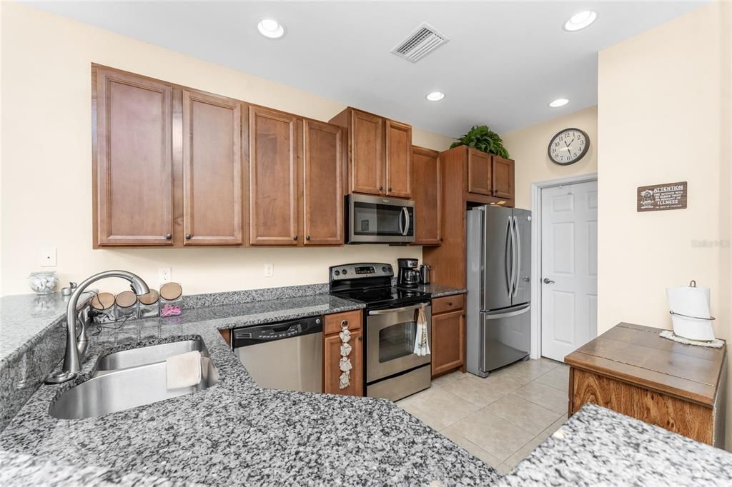 The kitchen has granite counter tops, a closet pantry for plenty of storage and stainless steel appliances.