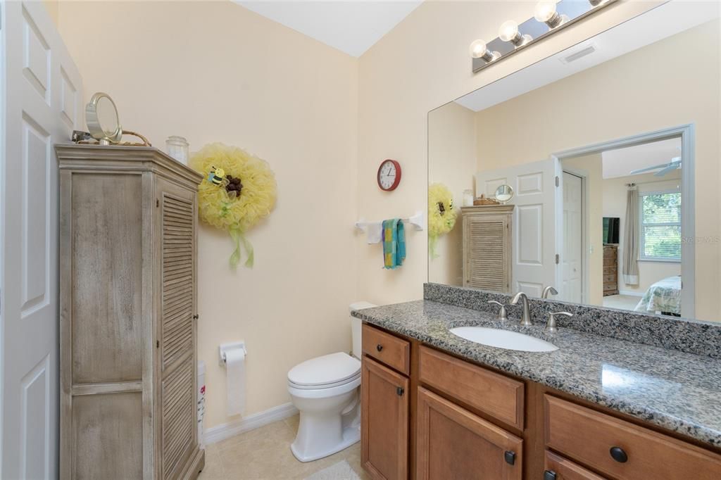 The vanity has a large mirror and bright lighting above it.