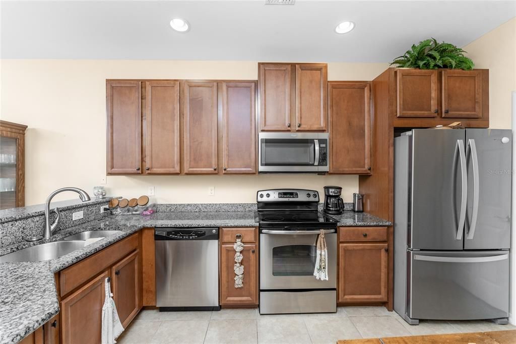 The kitchen features a GE dishwasher, GE smooth top stove, Whirlpool microwave and a Whirlpool french door refrigerator.