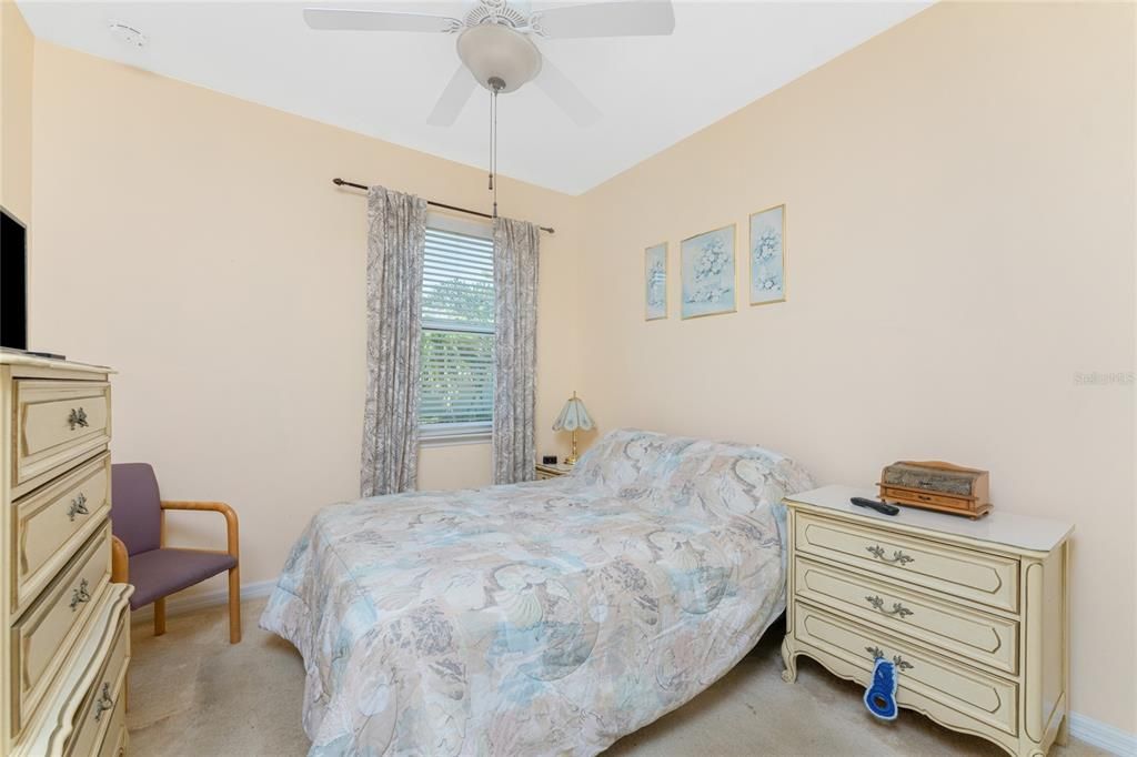 Bedroom 2 has carpeted flooring and a ceiling.