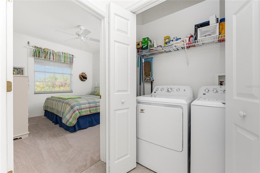 Looking into 2nd guest bedroom - laundry facllity between bedroom and guest bathroom