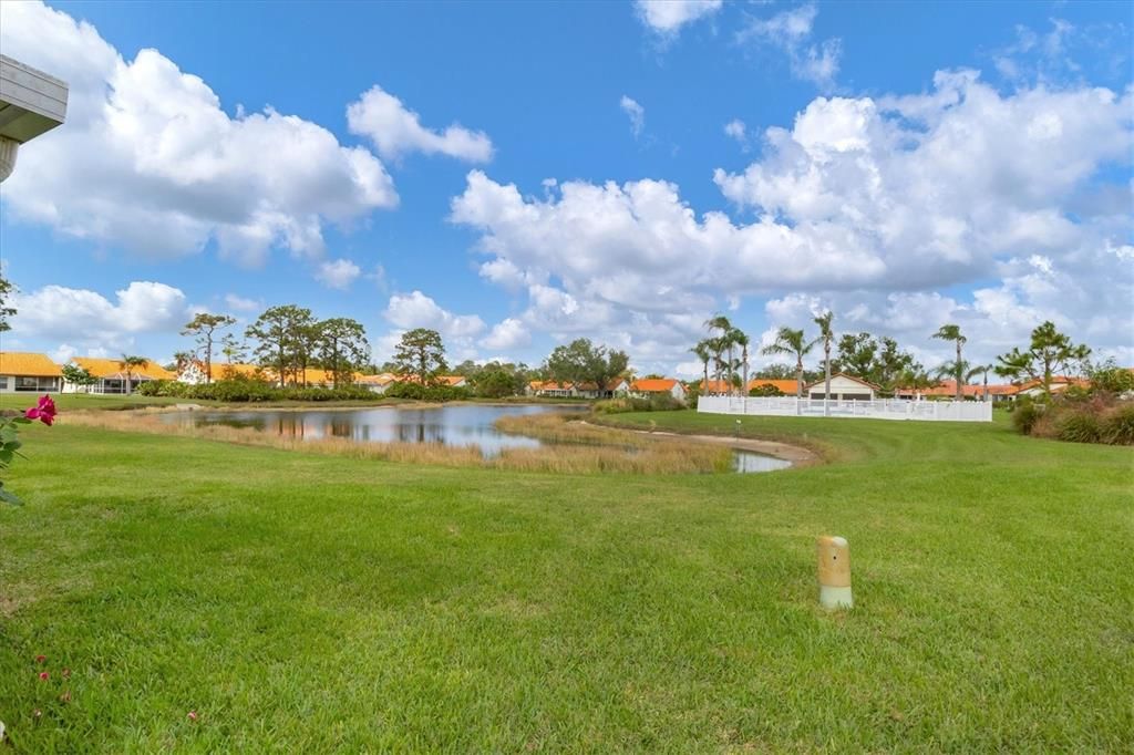 Peaceful backyard and lake view (white fence in distance is community pool)