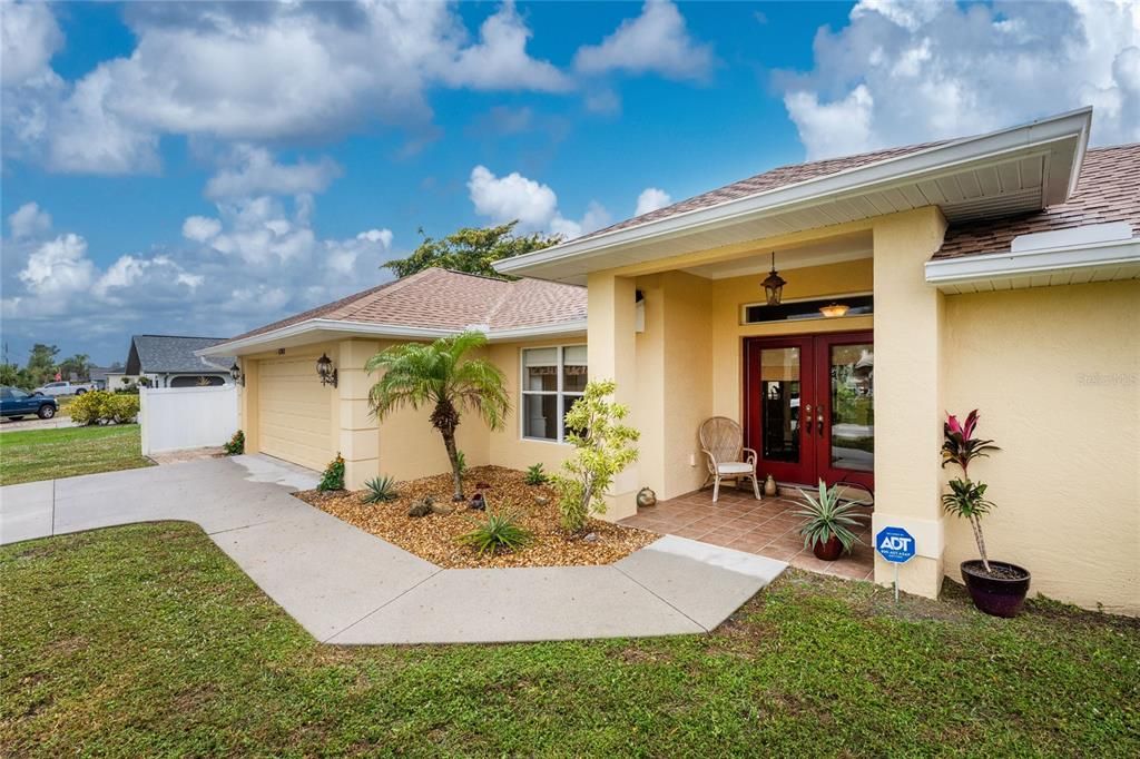 Landscaped area and a covered entry way with double glass doors usher you in!