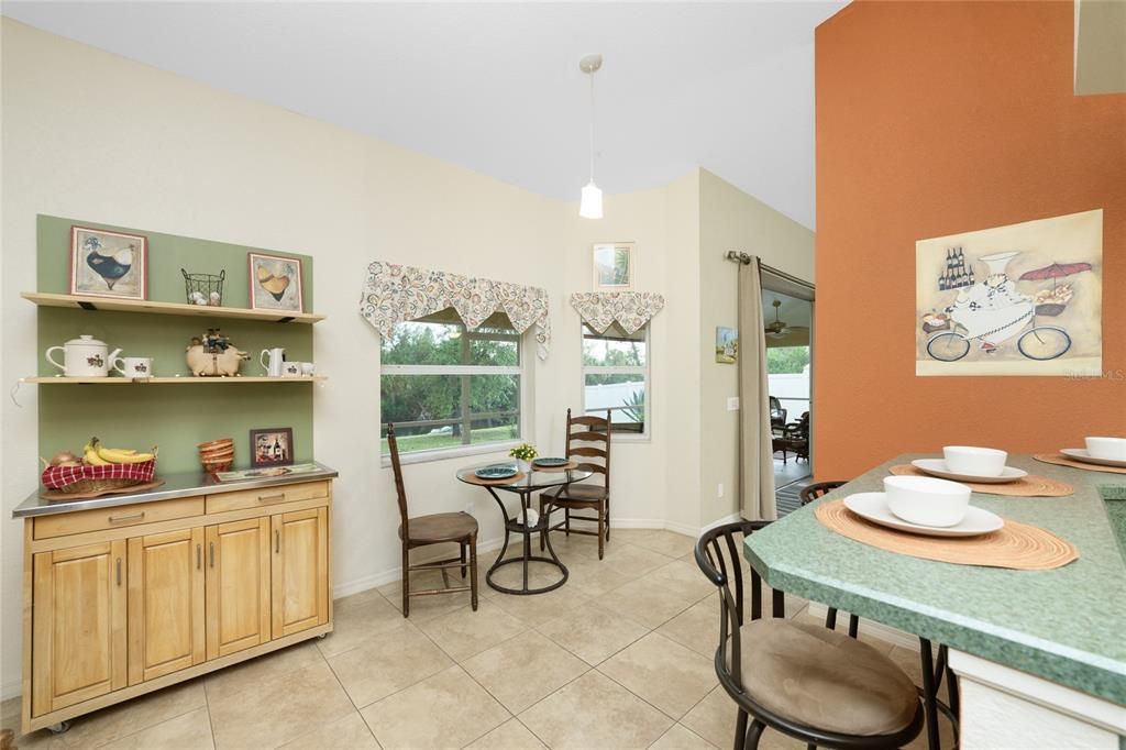 Kitchen features a breakfast nook area, plus a breakfast bar.