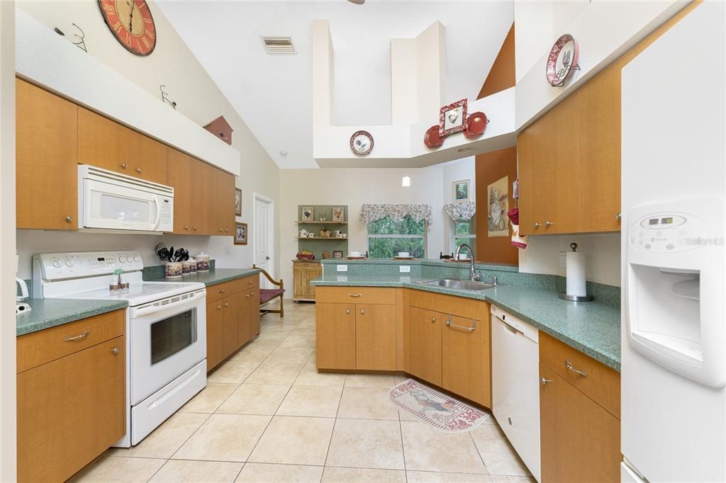 Kitchen is open with tiled flooring and has ample cabinetry and counter space for all your cooking needs.