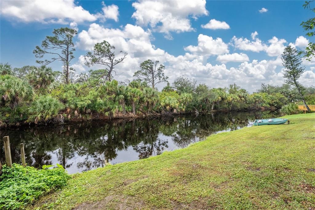 A nice and tranquil backyard borders the freshwater canal leading to Blueberry Lake.