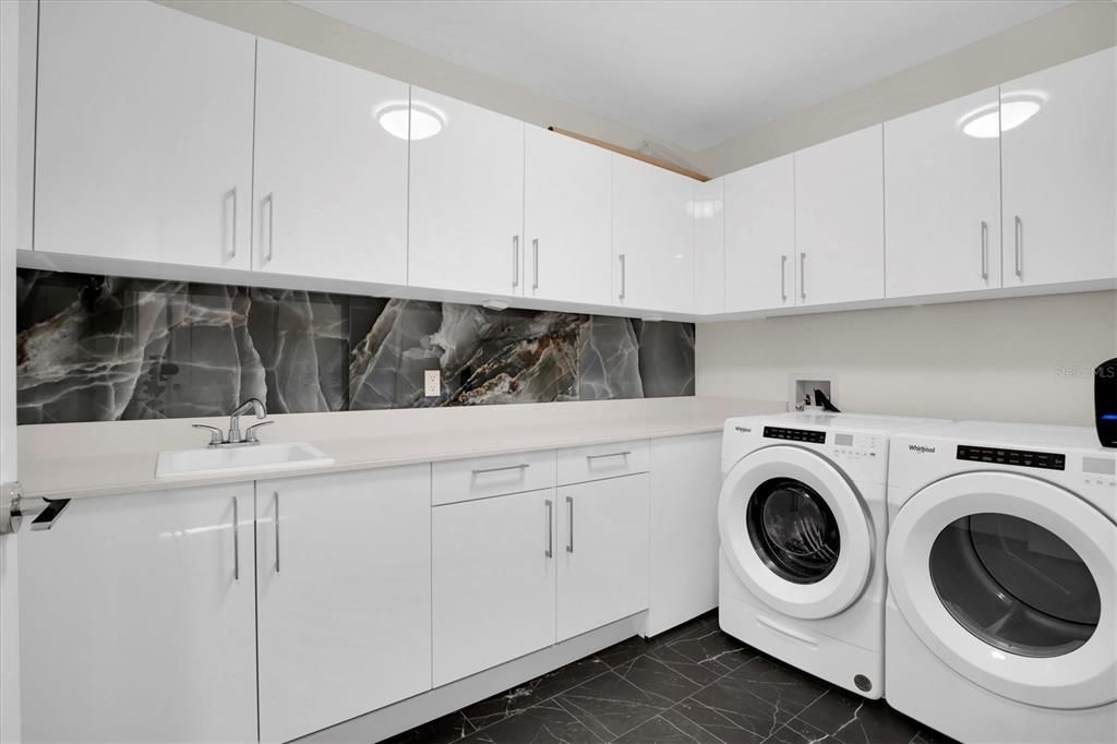 laundry room with upgraded backsplash