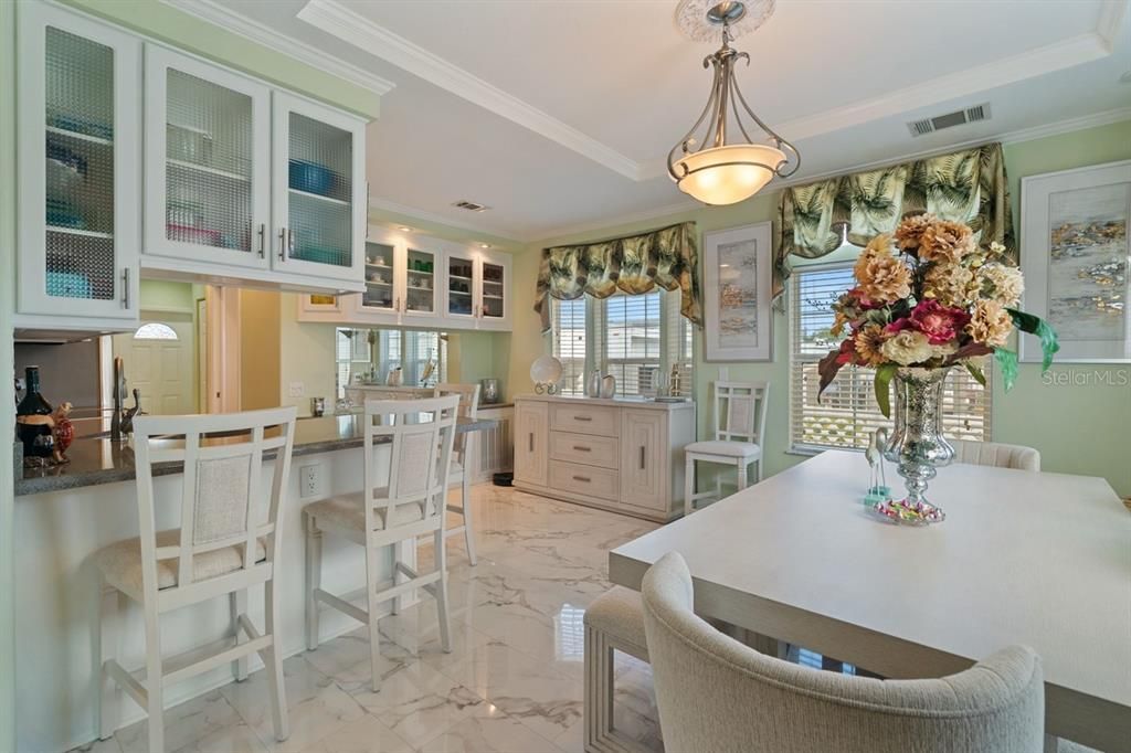 kitchen with eat at bar, dining area and built in hutch