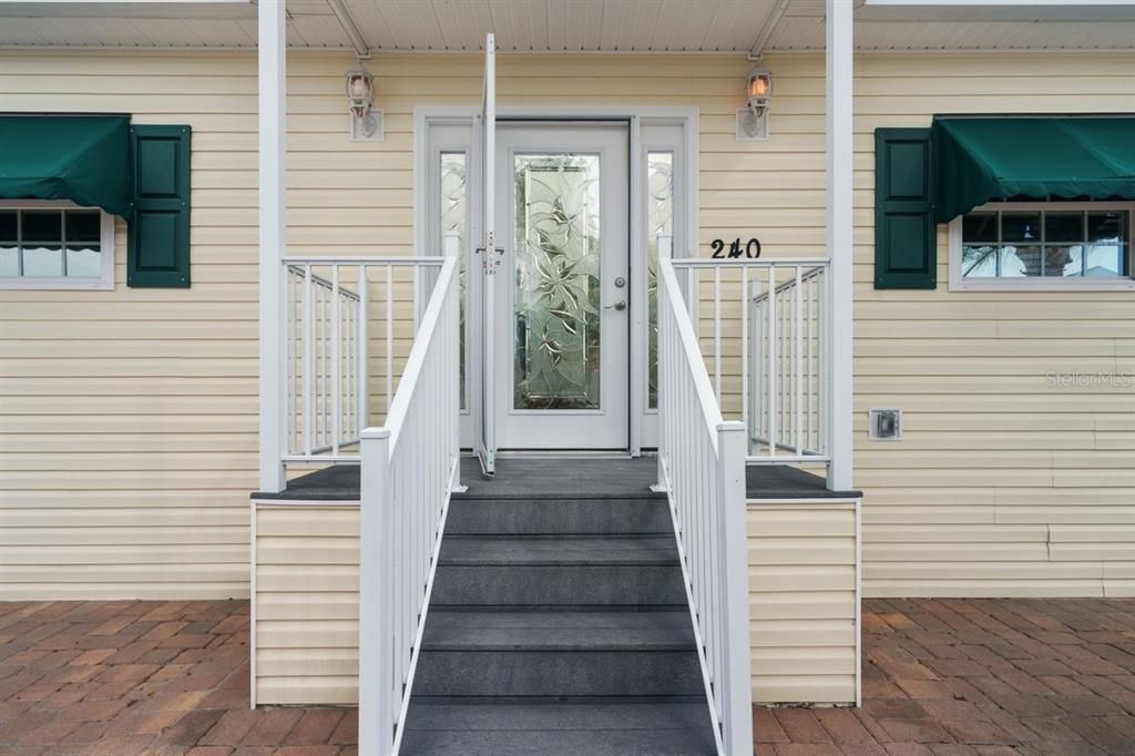 covered front entrance with beautiful stain glass door