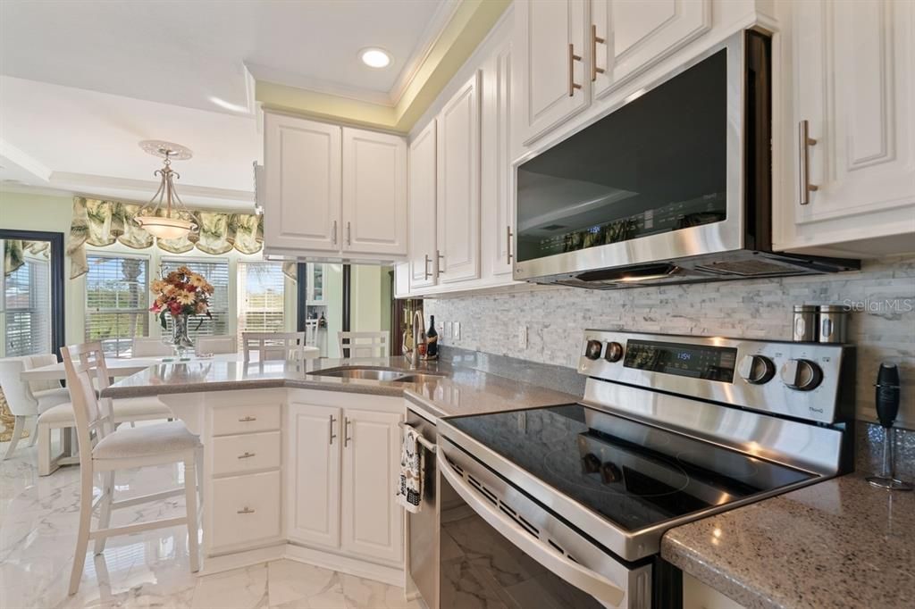 kitchen with eat at bar and quartz countertops