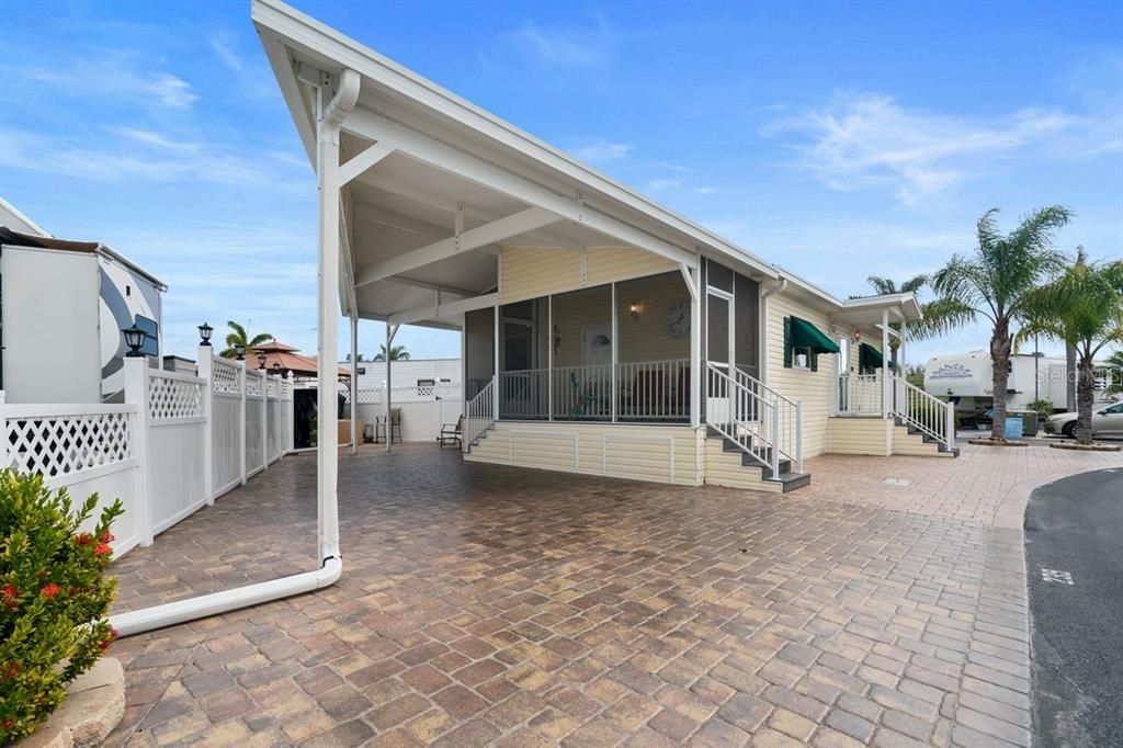 Carport and side porch surrounded by pavers