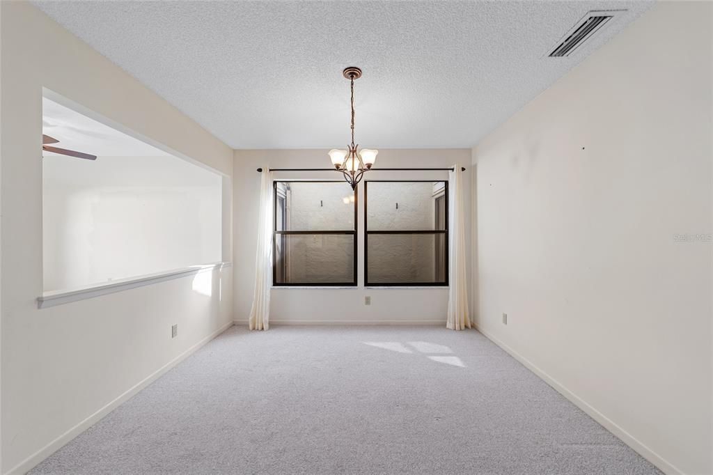 Formal dining room with windows to the atrium