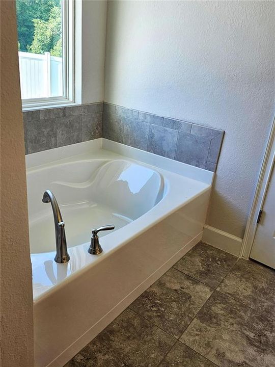 Primary bath garden tub, photo is stock photo colors vary