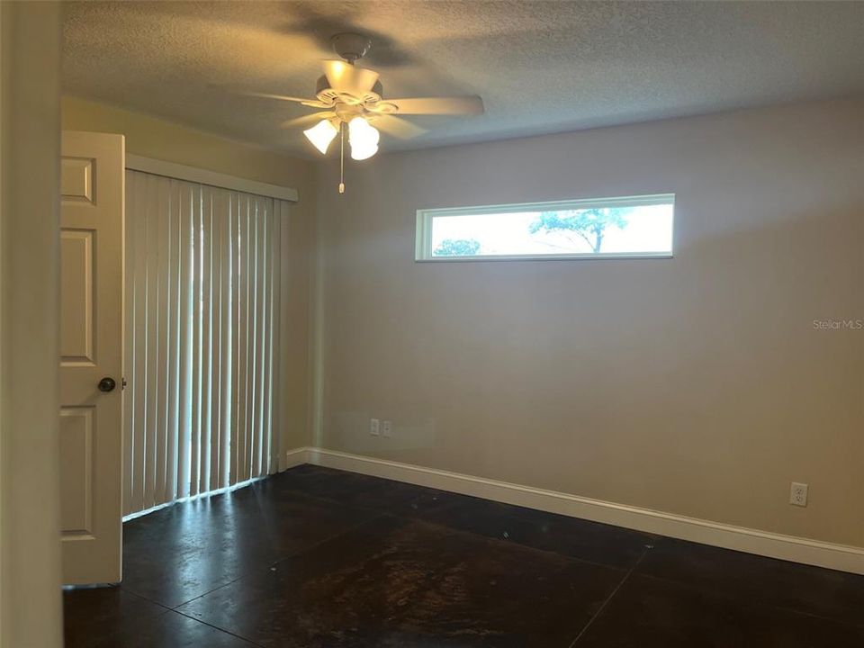 PRIMARY BEDROOM WITH SLIDING DOOR TO PATIO