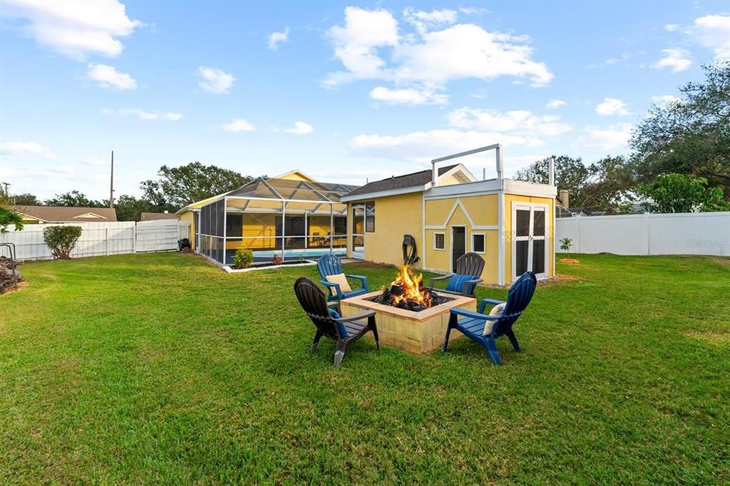 back yard with fire pit and storage shed