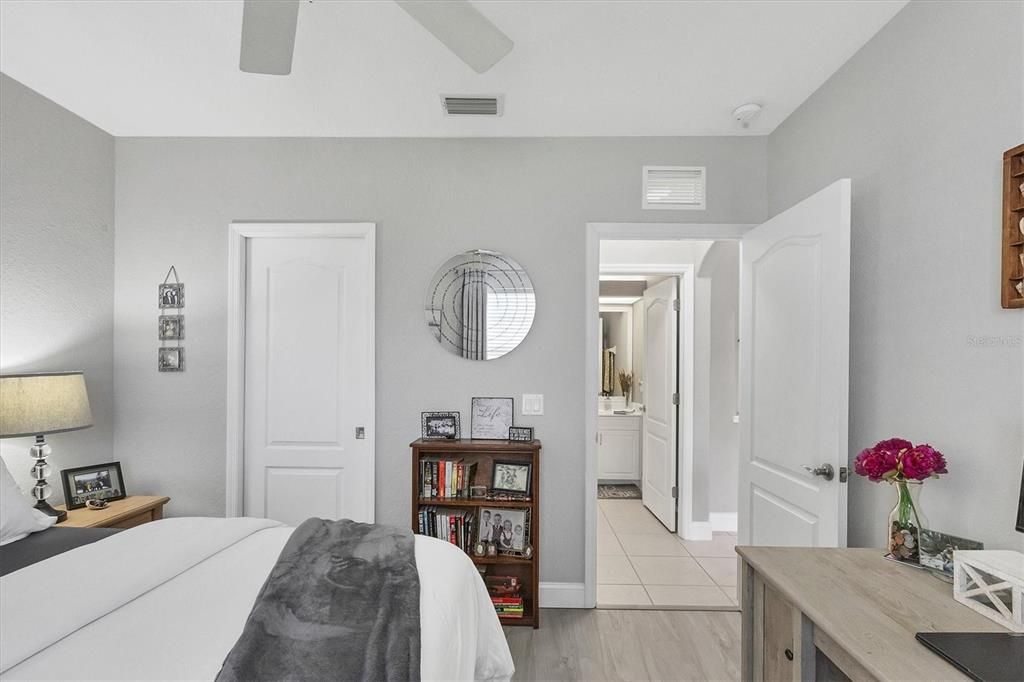 Guest Bedroom Featuring Walk in Closets and Wide Base Boards Throughout