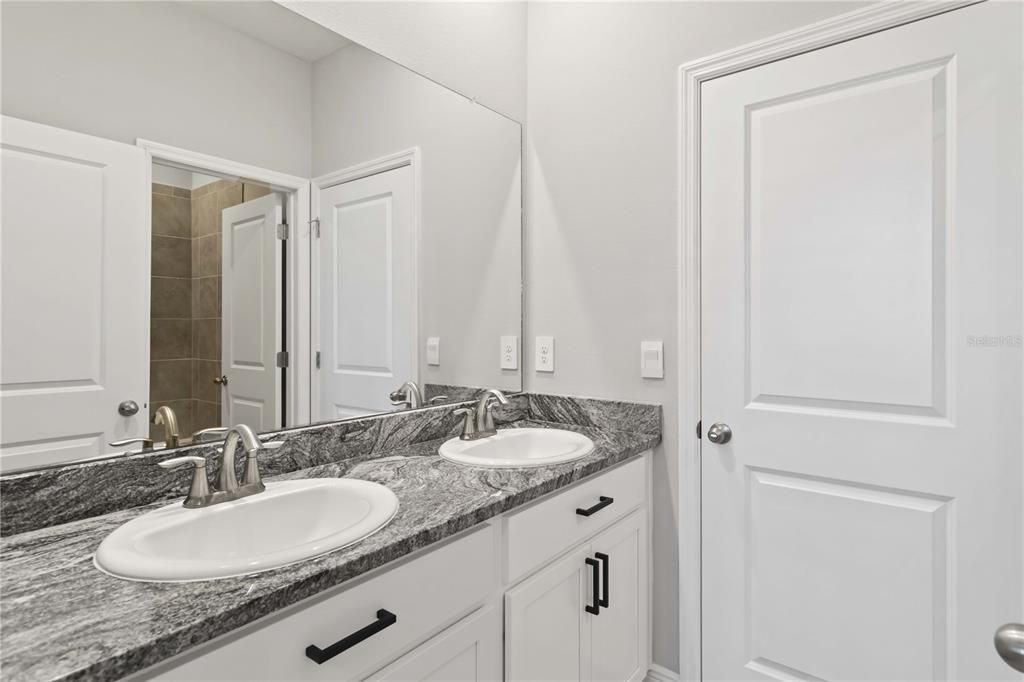 Jack and Jill Bath with Tub/ Shower and two sinks.