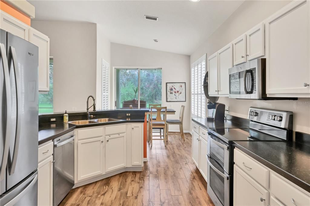 The kitchen also features stainless steel appliances and a double oven range.