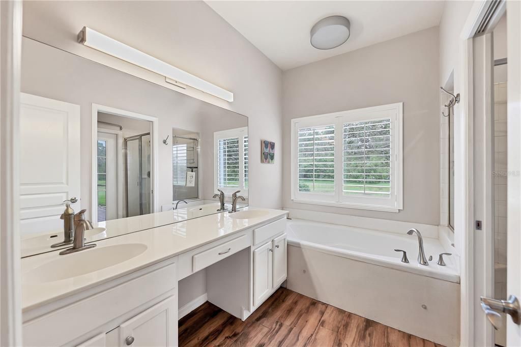 Owners ensuite bathroom featuring dual sinks, and a garden tub.