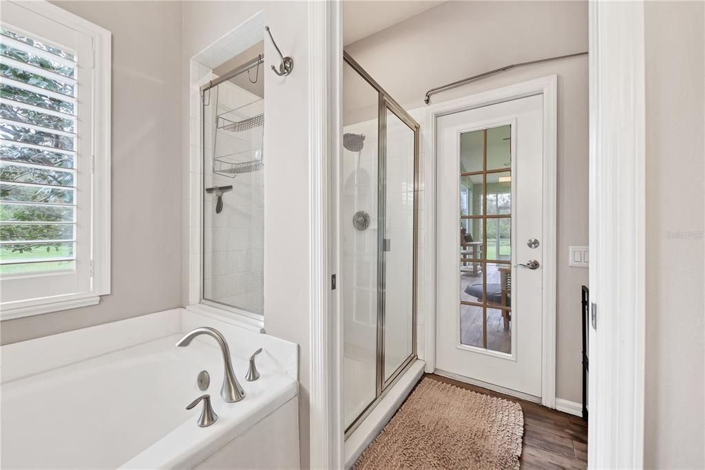 Owners ensuite bathroom also includes a glass enclosed walk-in shower and access to the screened-in lanai.