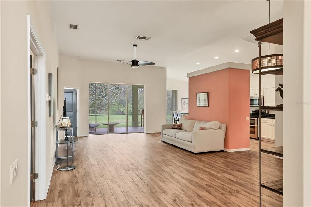 Spacious great room with plank tile floors and high ceilings.