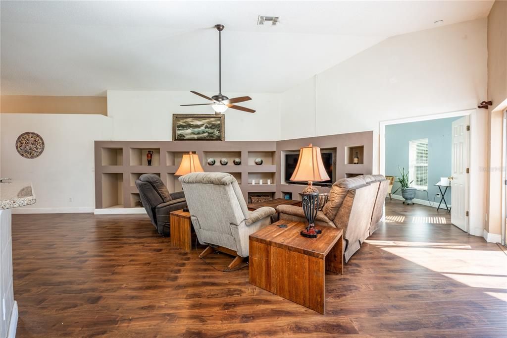 There are TILE and ENGINEERED HARDWARD FLOORS throughout making maintenance a breeze, HIGH CEILINGS, built-in features and the COVERED LANAI and SCREENED POOL are the cherry on top.