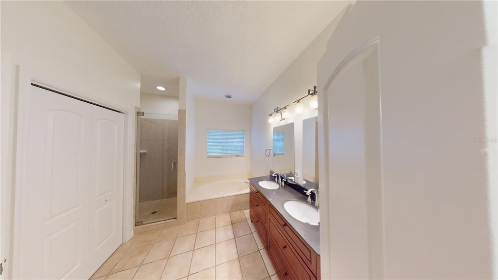 Primary Bathroom has a linen closet, separate W/C, soaking tub and separate shower