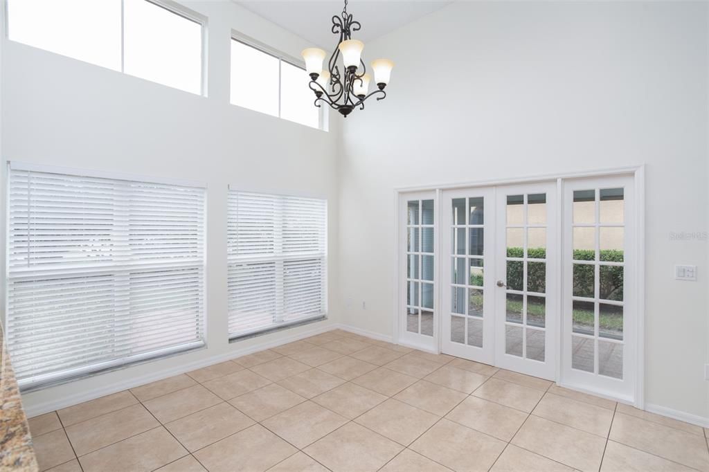 Kitchen with Eat-In Area looking toward French Doors of Enclosed Sun Room