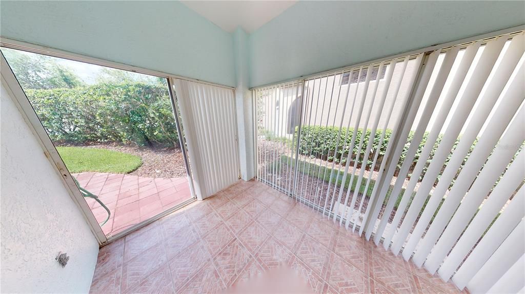 Enclosed Sun Room leads to the back patio.