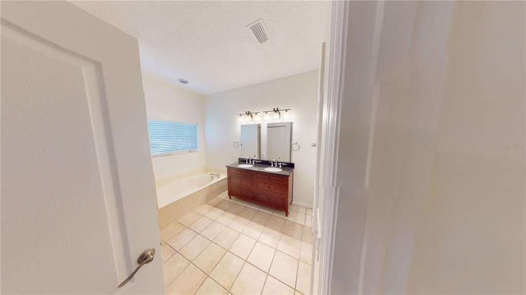 Primary Bathroom has a linen closet, separate W/C, soaking tub and separate shower